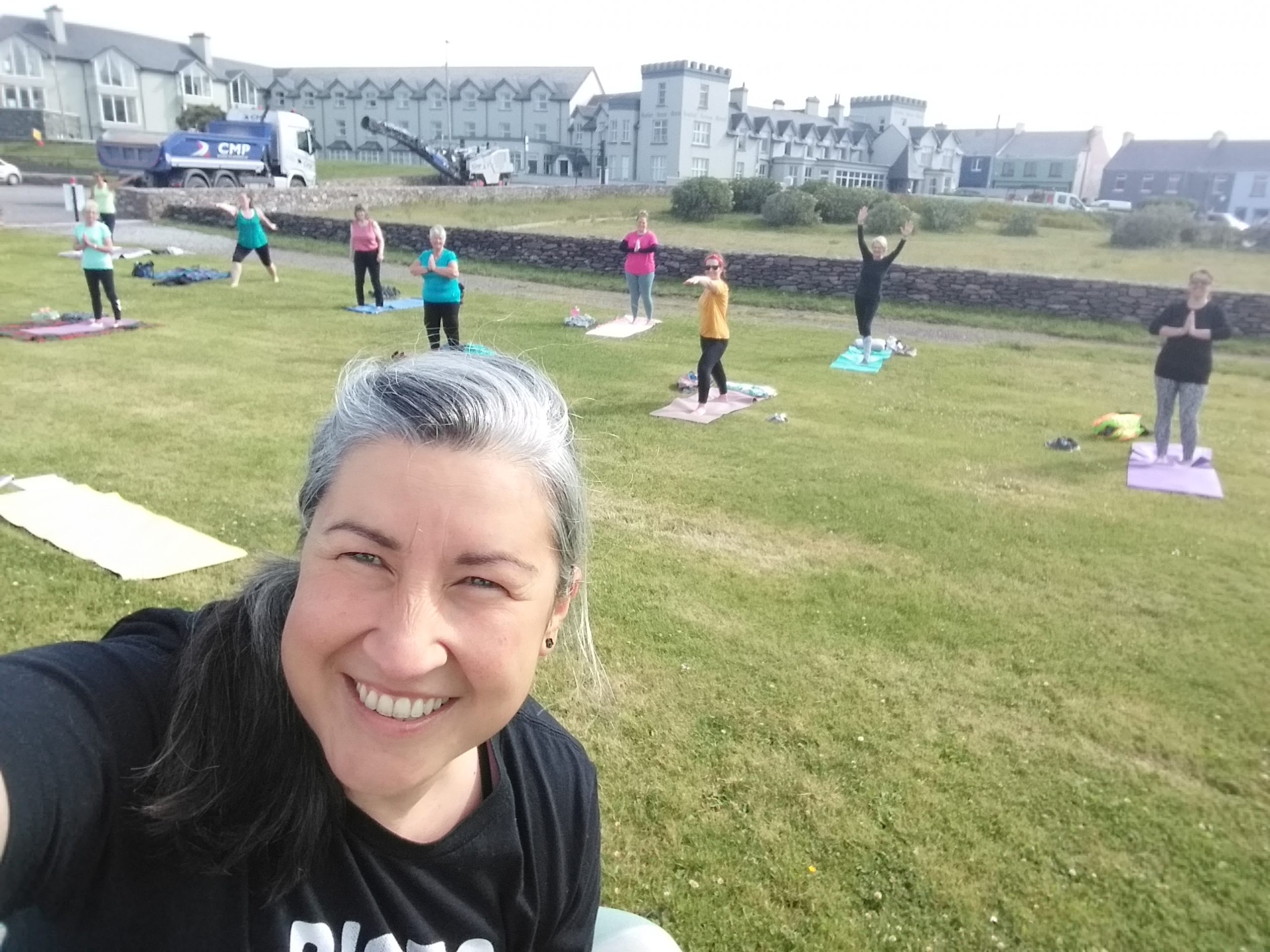 Yoga teacher and class outside in Waterville